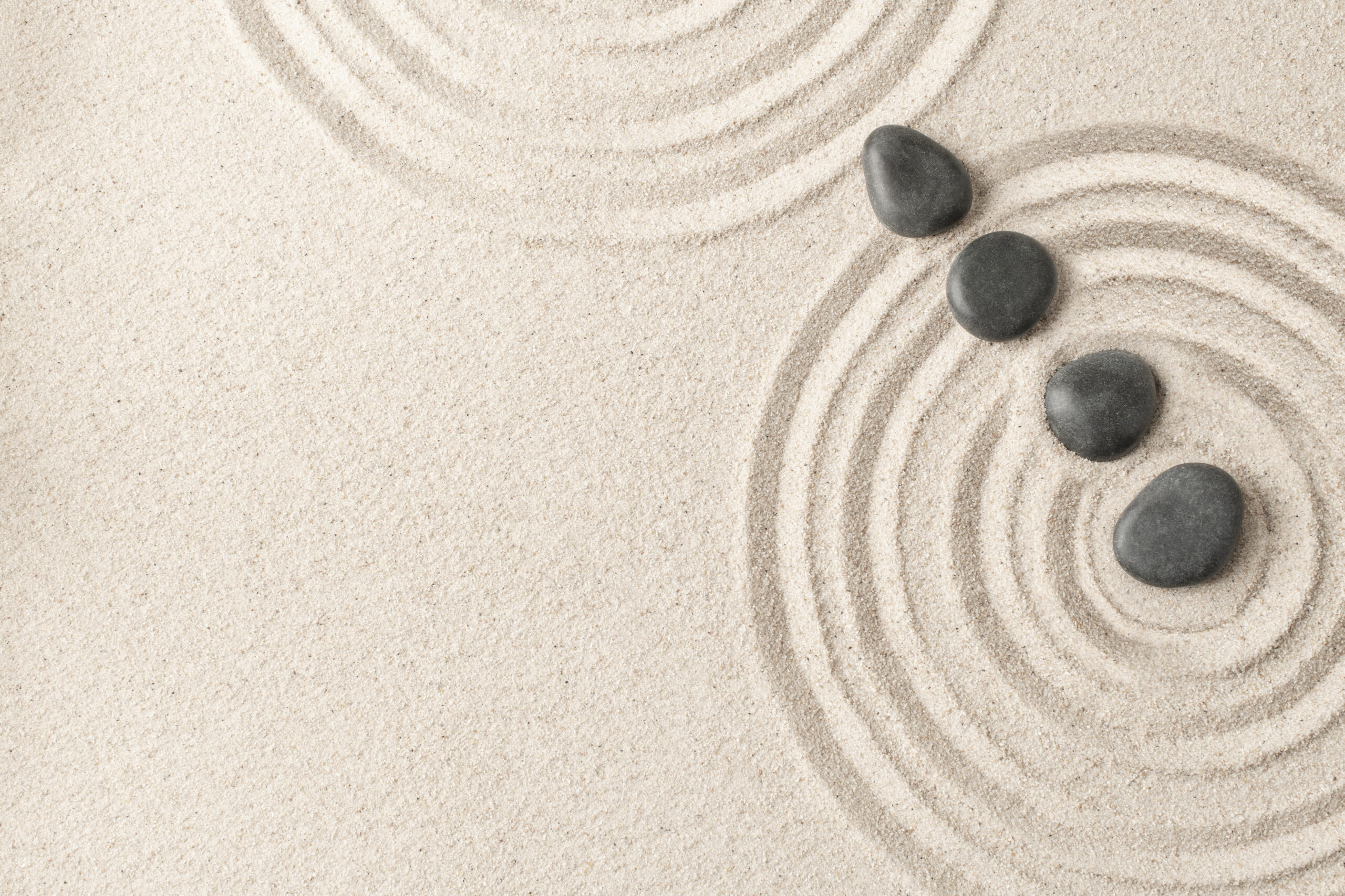 zen stones sand background health and wellness concept